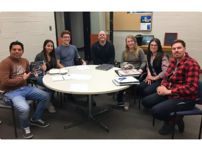 ANSC 3040 A group of graduate students and researchers from the ANSC 3040 course sitting around a circular table during a collaborative study session in a university lounge.