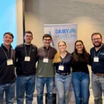 Outreach Matias, Genaro, Santiago, Alicia, Amanda and Dr. Ribeiro standing together in front of a "Dairy at Guelph" banner during the Dairy at Guelph Research Showcase 2025.